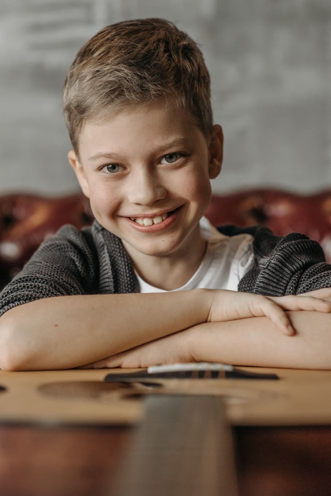 A young boy smiling at a table